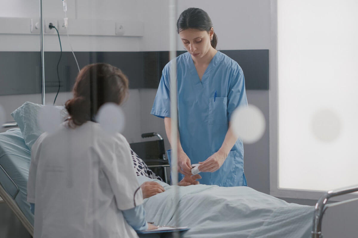 A doctor and a healthcare professional checking a patient's condition