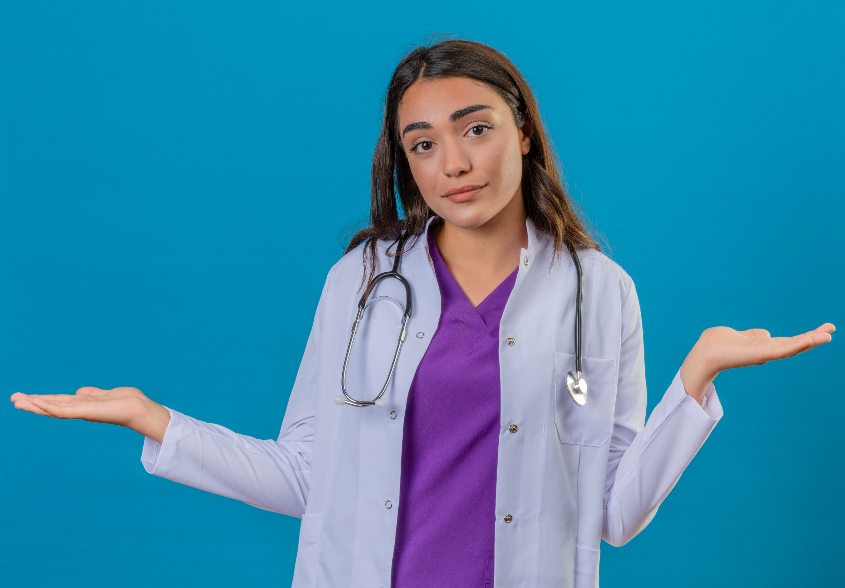 A young woman wearing a doctor's white coat